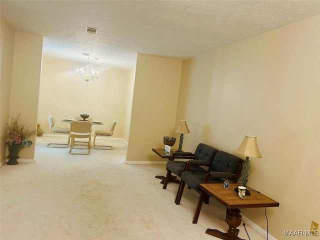 108 Shawnee Dr, Wetumpka, AL 36092 - sitting room with a chandelier, carpet flooring, a textured ceiling, and baseboards