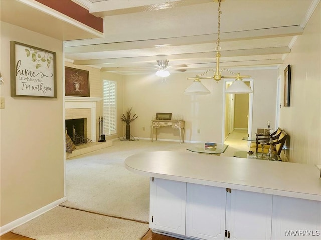 108 Shawnee Dr, Wetumpka, AL 36092 - kitchen featuring open floor plan, beamed ceiling, baseboards, light countertops, and a brick fireplace