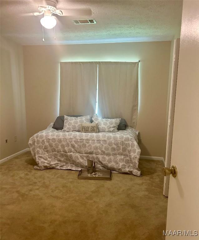108 Shawnee Dr, Wetumpka, AL 36092 - carpeted bedroom featuring baseboards, a textured ceiling, and a ceiling fan