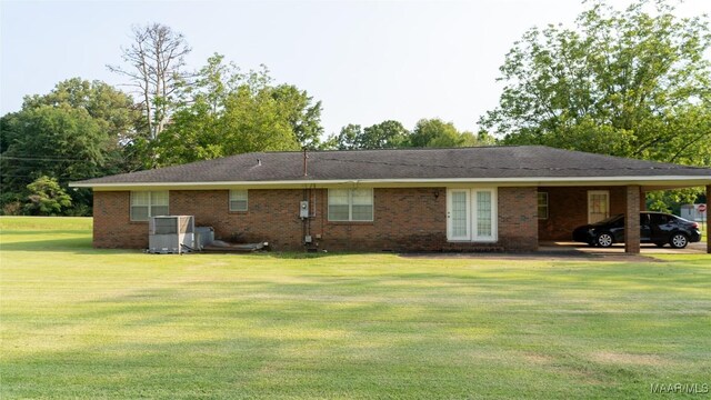 22 Daleview Cir, Sylacauga, AL 35150 - back of property with a yard, an attached carport, and brick siding