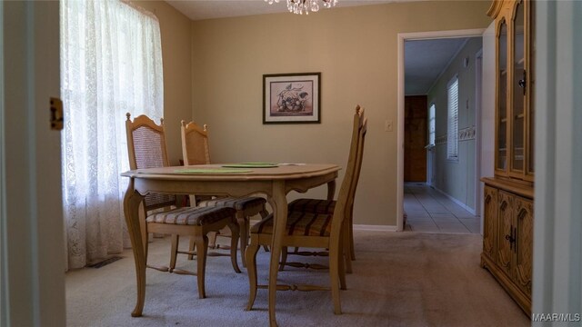22 Daleview Cir, Sylacauga, AL 35150 - dining space with light colored carpet, a chandelier, and baseboards