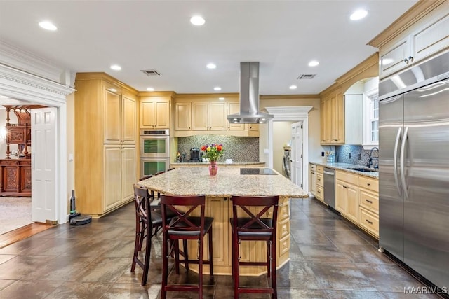 161 Watson Cir, Montgomery, AL 36109 - kitchen with stainless steel appliances, island exhaust hood, a sink, a kitchen island, and light stone countertops