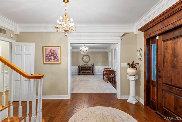 161 Watson Cir, Montgomery, AL 36109 - foyer featuring a chandelier, dark wood-style floors, crown molding, stairs, and wainscoting
