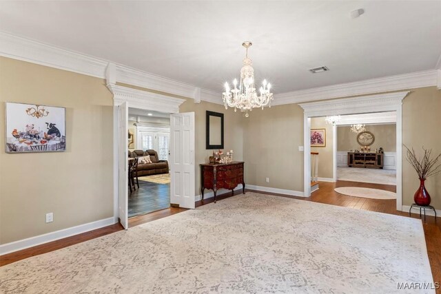 161 Watson Cir, Montgomery, AL 36109 - unfurnished room featuring a chandelier, crown molding, wood finished floors, and baseboards