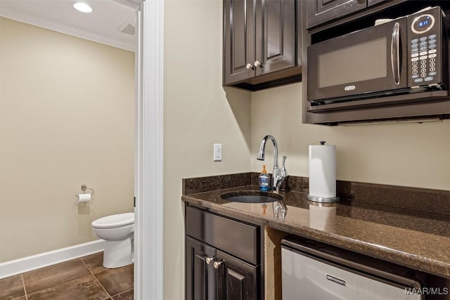 161 Watson Cir, Montgomery, AL 36109 - kitchen featuring black microwave, a sink, dishwasher, dark tile patterned flooring, and dark stone counters
