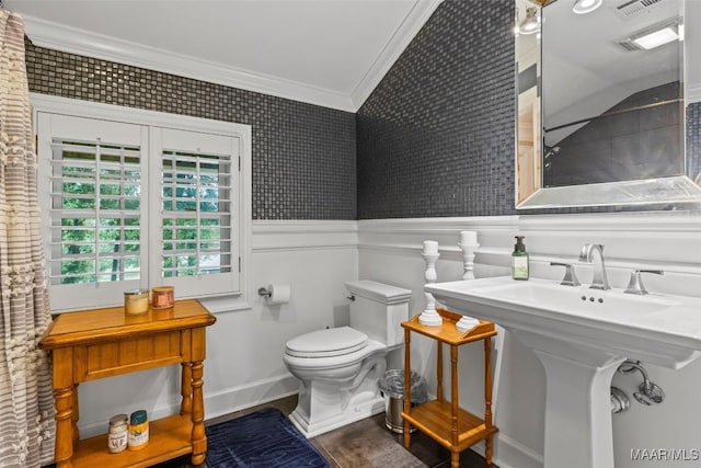 161 Watson Cir, Montgomery, AL 36109 - bathroom featuring crown molding, toilet, baseboards, and a wainscoted wall