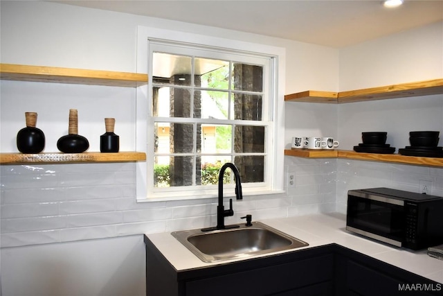 402 S Perry St, Montgomery, AL 36104 - kitchen with a sink, open shelves, backsplash, and light countertops