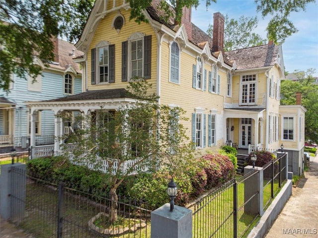 402 S Perry St, Montgomery, AL 36104 - view of front facade with a chimney, a fenced front yard, and french doors
