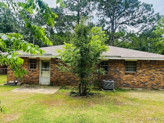 519 Woodbrook Dr, Montgomery, AL 36110 - rear view of house featuring brick siding, a yard, a patio, and central AC unit
