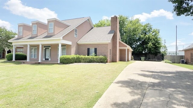 1571 Meriwether Cir, Montgomery, AL 36117 - view of front of property featuring a porch, a shingled roof, driveway, stucco siding, and a chimney