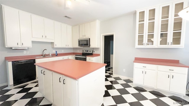 1571 Meriwether Cir, Montgomery, AL 36117 - kitchen with appliances with stainless steel finishes, light floors, a sink, a center island, and white cabinets