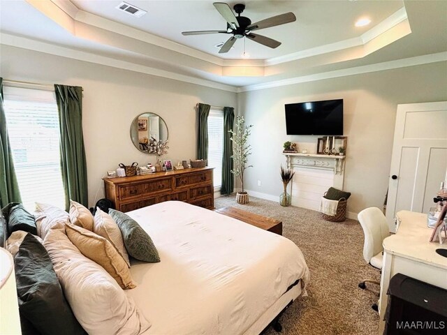 1670 Rifle Range Rd, Wetumpka, AL 36093 - carpeted bedroom featuring a raised ceiling, crown molding, a ceiling fan, and baseboards