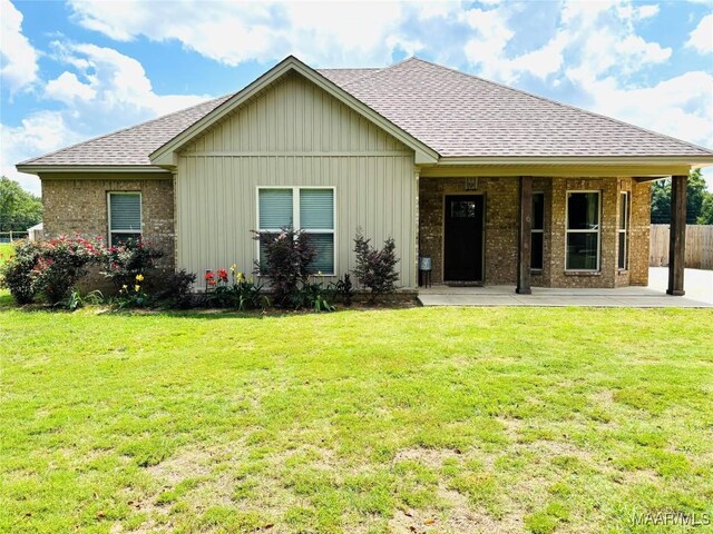1670 Rifle Range Rd, Wetumpka, AL 36093 - back of house with a shingled roof, brick siding, a porch, and board and batten siding