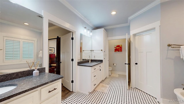 3063 Little Rd, Tallassee, AL 36078 - full bath featuring crown molding, two vanities, toilet, recessed lighting, and baseboards