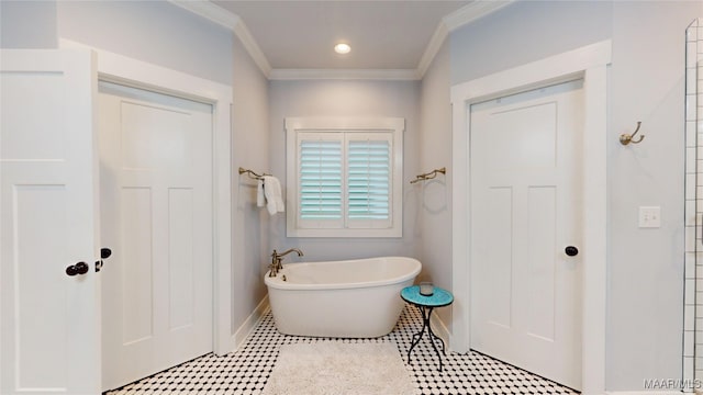 3063 Little Rd, Tallassee, AL 36078 - full bathroom featuring a soaking tub, ornamental molding, and baseboards