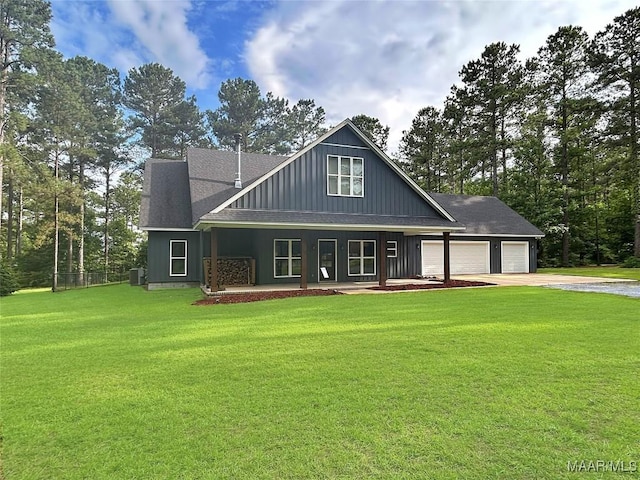 3063 Little Rd, Tallassee, AL 36078 - view of front of home featuring concrete driveway, an attached garage, a porch, a front yard, and board and batten siding
