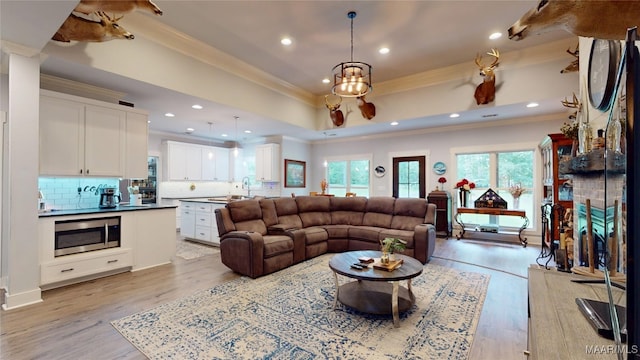 3063 Little Rd, Tallassee, AL 36078 - living area with crown molding, light wood-type flooring, recessed lighting, a tray ceiling, and a chandelier