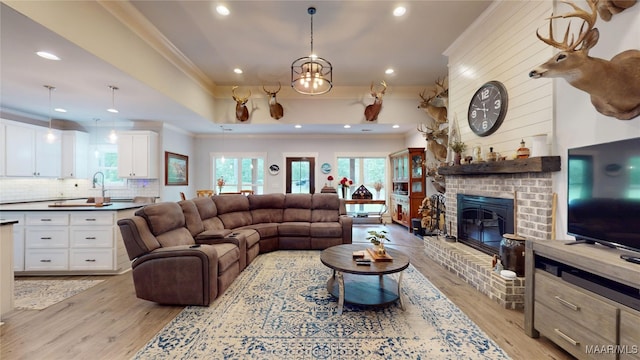 3063 Little Rd, Tallassee, AL 36078 - living area with crown molding, light wood-type flooring, a fireplace, and recessed lighting
