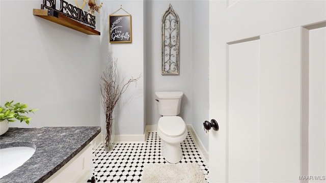 3063 Little Rd, Tallassee, AL 36078 - bathroom with toilet, vanity, tile patterned flooring, and baseboards