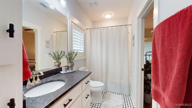 3063 Little Rd, Tallassee, AL 36078 - full bathroom with vanity, toilet, tile patterned flooring, and a shower with shower curtain