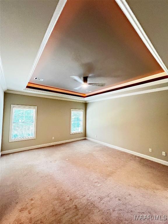 475 Mountain Meadows Ln, Wetumpka, AL 36093 - spare room with crown molding, a tray ceiling, carpet, ceiling fan, and baseboards