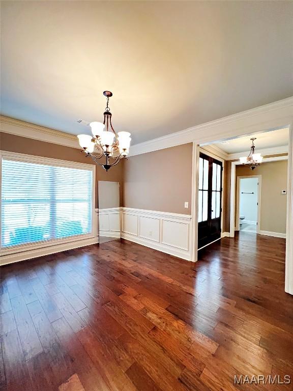 475 Mountain Meadows Ln, Wetumpka, AL 36093 - spare room featuring a chandelier, ornamental molding, dark wood-style flooring, and wainscoting