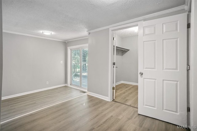 21 Judge Ests, Hope Hull, AL 36043 - unfurnished bedroom with a textured ceiling, access to exterior, wood finished floors, baseboards, and ornamental molding