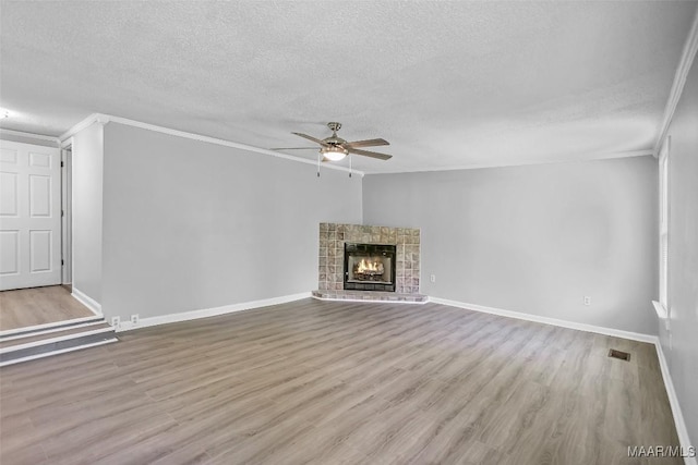 21 Judge Ests, Hope Hull, AL 36043 - unfurnished living room with ornamental molding, ceiling fan, a textured ceiling, wood finished floors, and baseboards
