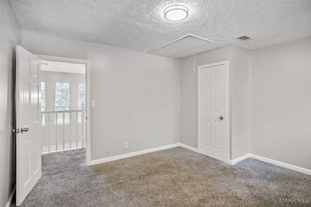 21 Judge Ests, Hope Hull, AL 36043 - empty room with attic access, a textured ceiling, carpet floors, and baseboards