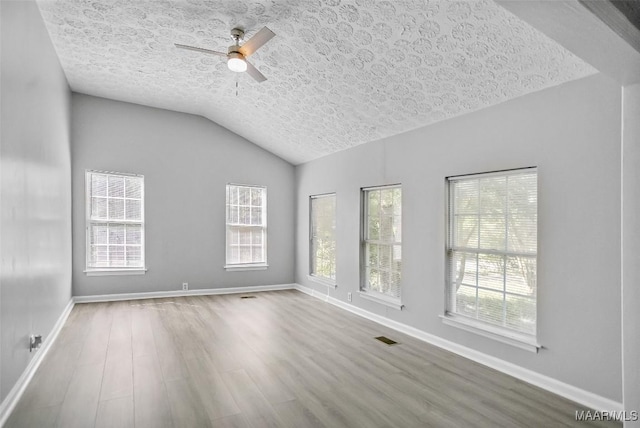 21 Judge Ests, Hope Hull, AL 36043 - empty room with wood finished floors, a ceiling fan, a textured ceiling, baseboards, and vaulted ceiling