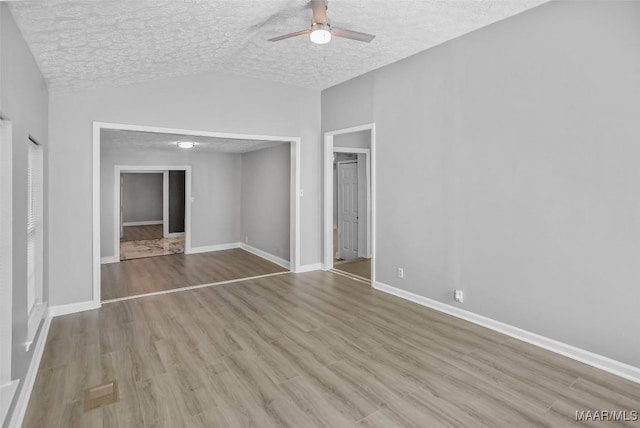 21 Judge Ests, Hope Hull, AL 36043 - spare room featuring a ceiling fan, vaulted ceiling, a textured ceiling, wood finished floors, and baseboards