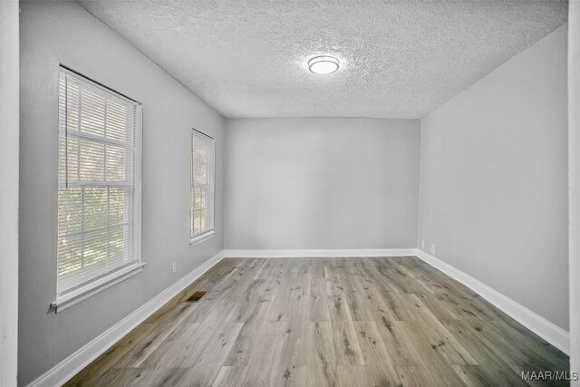 21 Judge Ests, Hope Hull, AL 36043 - spare room featuring wood finished floors, a textured ceiling, and baseboards