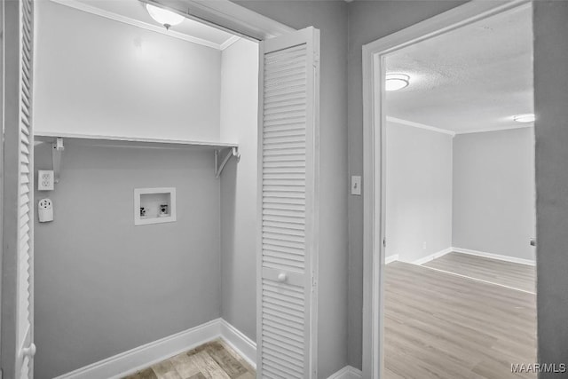 21 Judge Ests, Hope Hull, AL 36043 - washroom featuring ornamental molding, washer hookup, wood finished floors, baseboards, and a textured ceiling