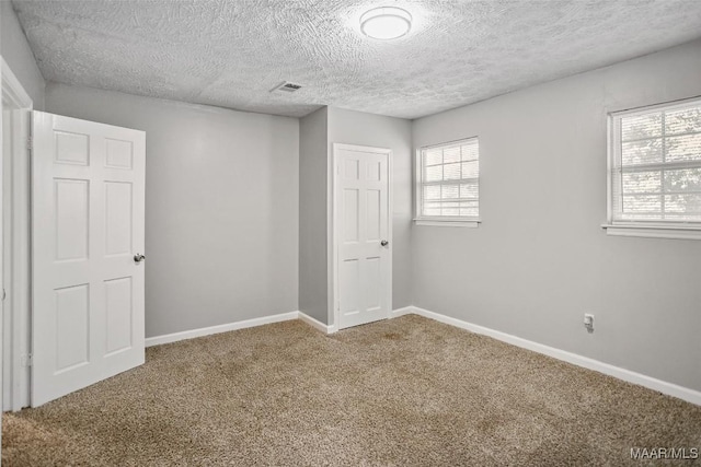 21 Judge Ests, Hope Hull, AL 36043 - unfurnished room featuring a textured ceiling, carpet flooring, and baseboards
