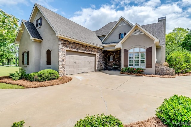 3900 Turning Leaf Loop, Montgomery, AL 36116 - view of front of property with stucco siding, driveway, roof with shingles, stone siding, and an attached garage
