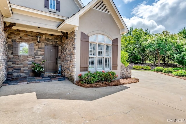 3900 Turning Leaf Loop, Montgomery, AL 36116 - property entrance featuring stone siding, stucco siding, and driveway