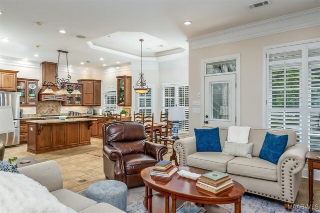 3900 Turning Leaf Loop, Montgomery, AL 36116 - living area with crown molding, recessed lighting, and a tray ceiling