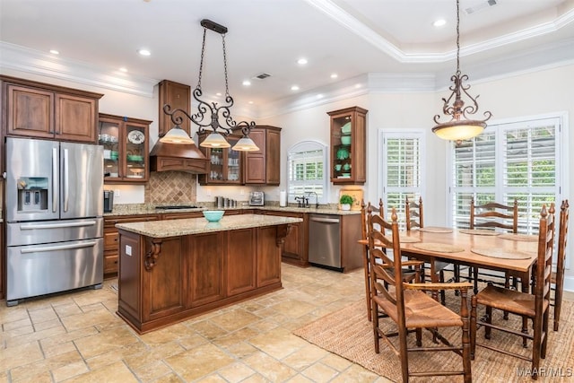 3900 Turning Leaf Loop, Montgomery, AL 36116 - kitchen with appliances with stainless steel finishes, stone tile floors, plenty of natural light, decorative backsplash, and crown molding