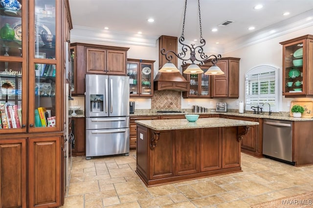 3900 Turning Leaf Loop, Montgomery, AL 36116 - kitchen featuring stainless steel appliances, stone tile flooring, ornamental molding, a kitchen island, and backsplash