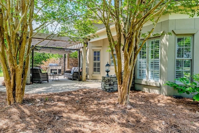3900 Turning Leaf Loop, Montgomery, AL 36116 - view of home's exterior featuring a patio area, stucco siding, and a pergola