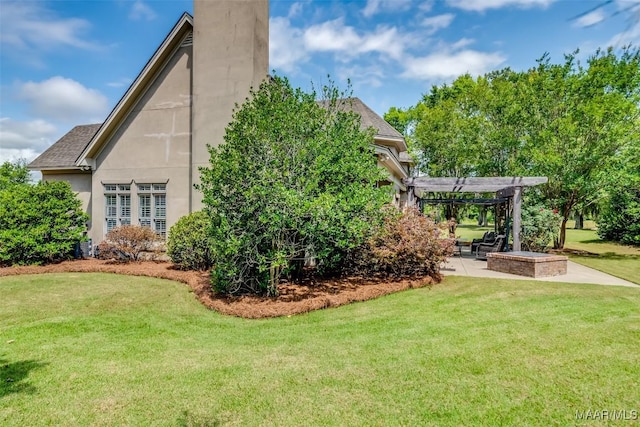3900 Turning Leaf Loop, Montgomery, AL 36116 - view of property exterior with a pergola, a patio area, a lawn, a chimney, and stucco siding