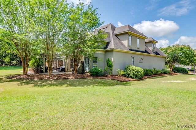 3900 Turning Leaf Loop, Montgomery, AL 36116 - view of front of house featuring stucco siding, a front yard, and a shingled roof