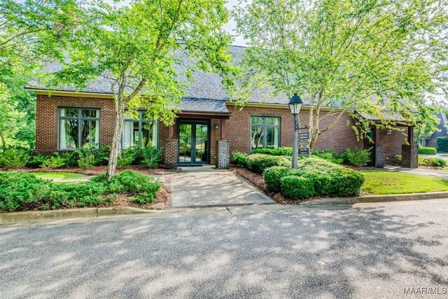 3900 Turning Leaf Loop, Montgomery, AL 36116 - english style home featuring french doors, brick siding, and roof with shingles