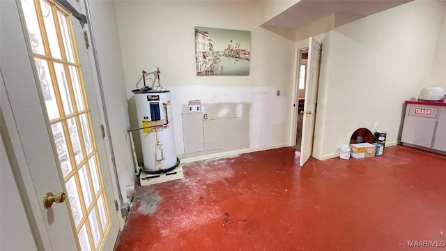 610 Booth Rd, Montgomery, AL 36108 - foyer with water heater, plenty of natural light, finished concrete flooring, and baseboards