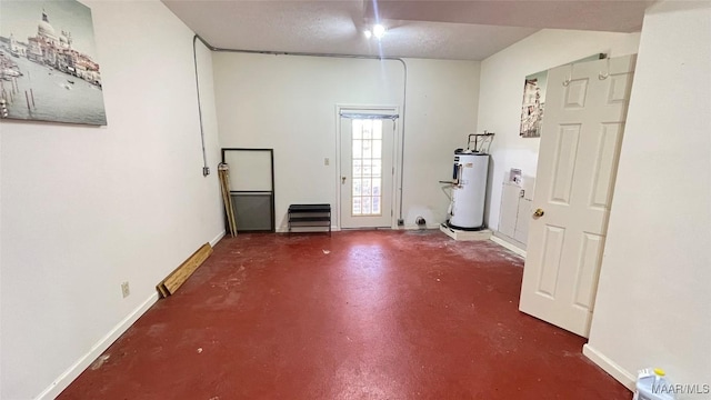 610 Booth Rd, Montgomery, AL 36108 - unfurnished room with water heater, finished concrete flooring, and baseboards