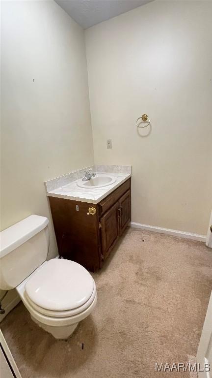 610 Booth Rd, Montgomery, AL 36108 - half bathroom with toilet, vanity, and baseboards