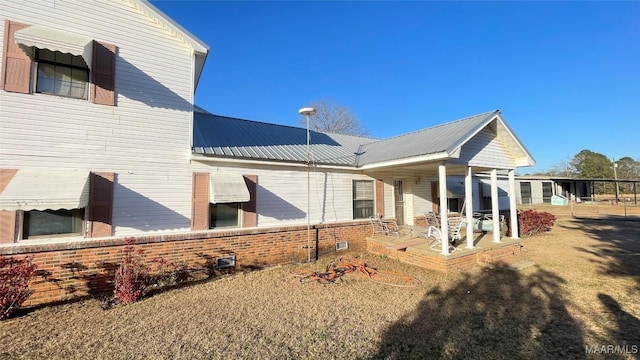 610 Booth Rd, Montgomery, AL 36108 - rear view of house featuring brick siding, a porch, and metal roof