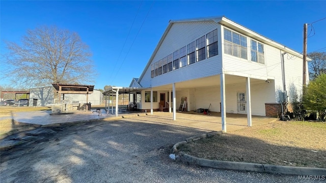 610 Booth Rd, Montgomery, AL 36108 - rear view of property with a patio area and a carport