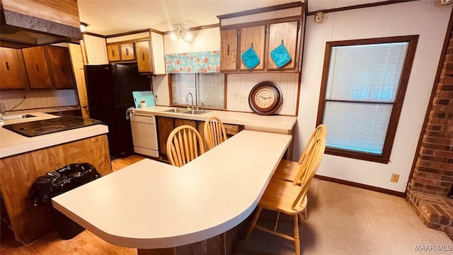 610 Booth Rd, Montgomery, AL 36108 - kitchen featuring a sink, custom range hood, black appliances, a kitchen bar, and baseboards