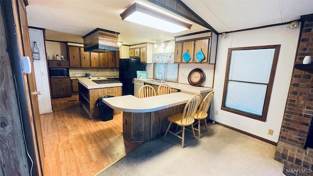 610 Booth Rd, Montgomery, AL 36108 - kitchen featuring light countertops, a sink, custom exhaust hood, a center island, and black appliances